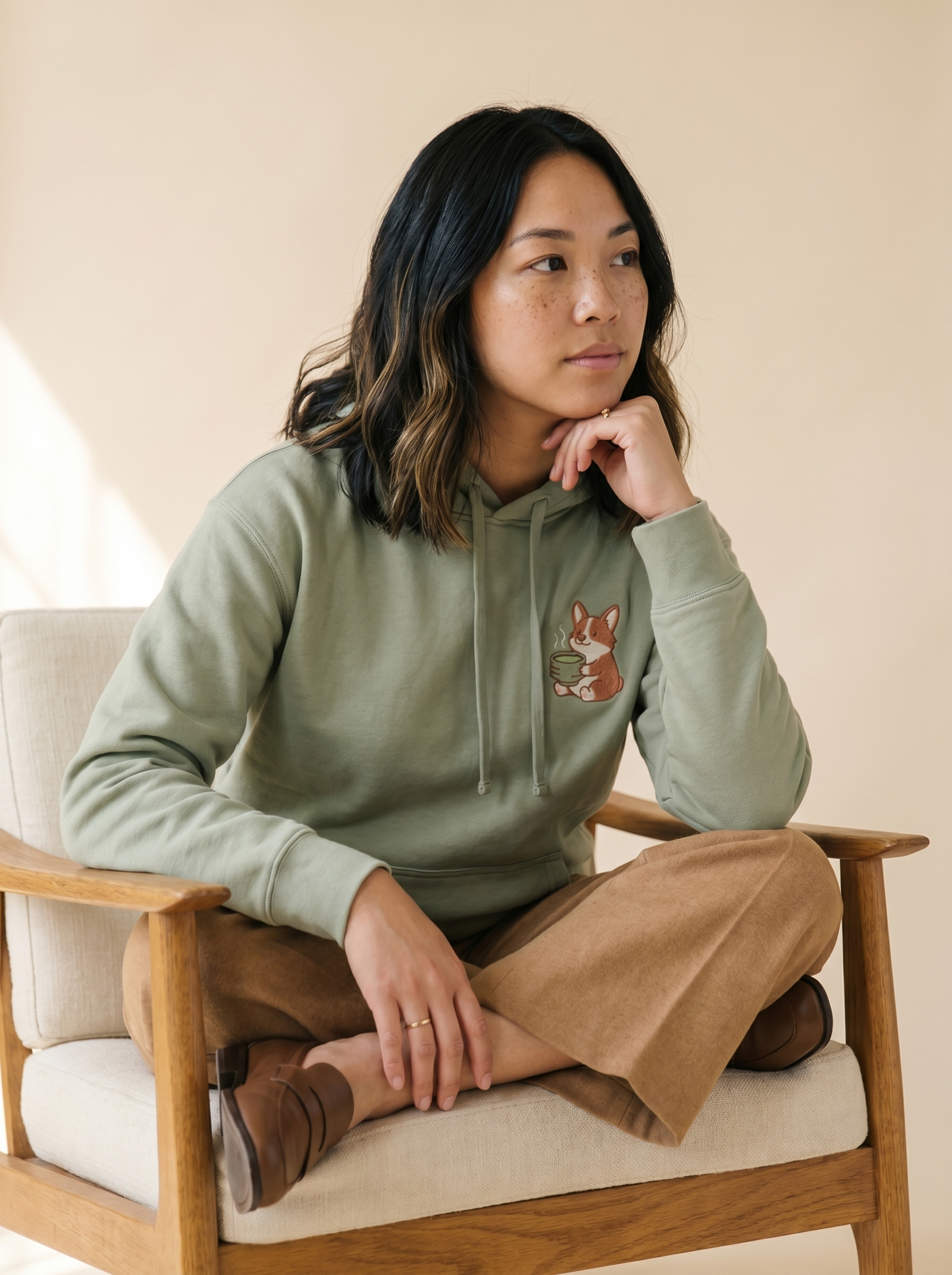 embroidered matcha latte corgi hoodie - model seated