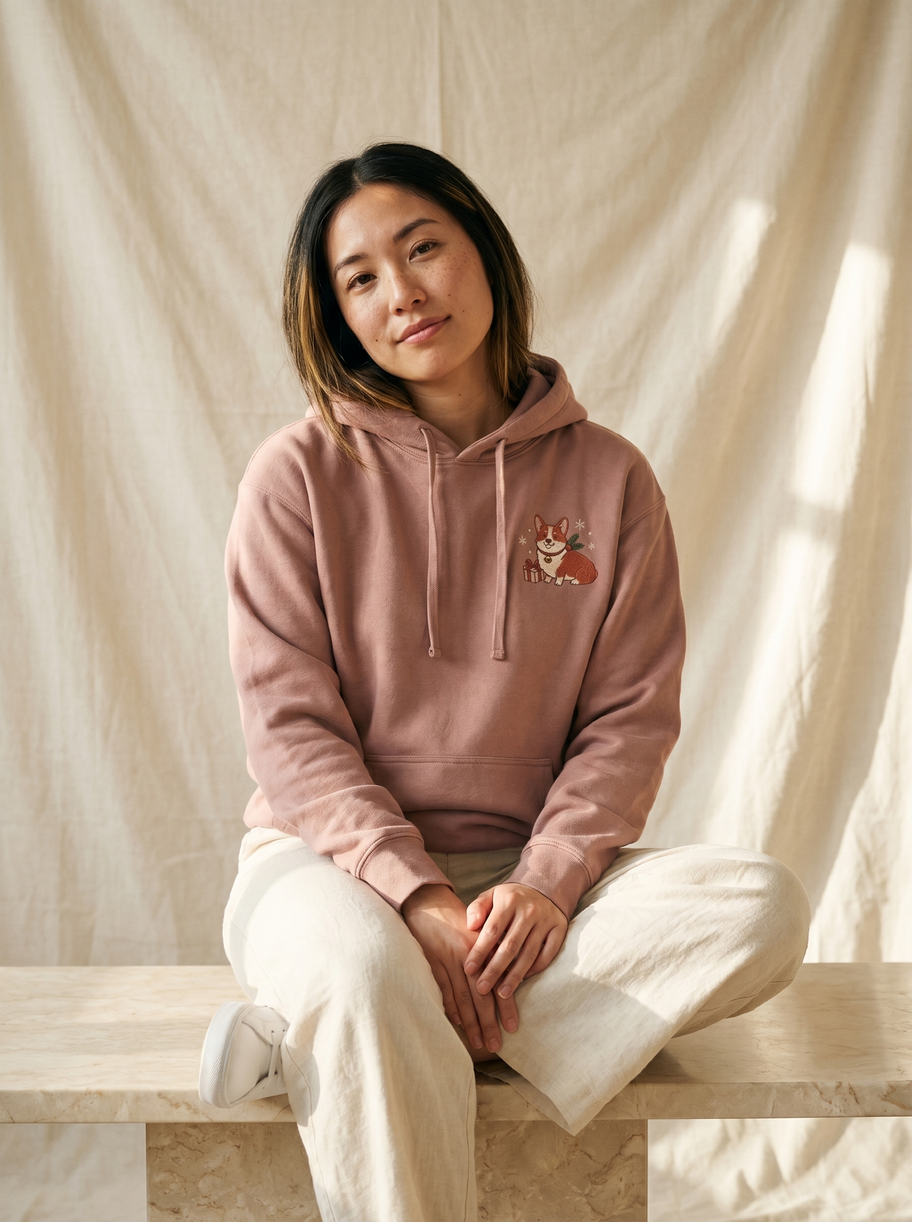 embroidered christmas corgi hoodie - model seated