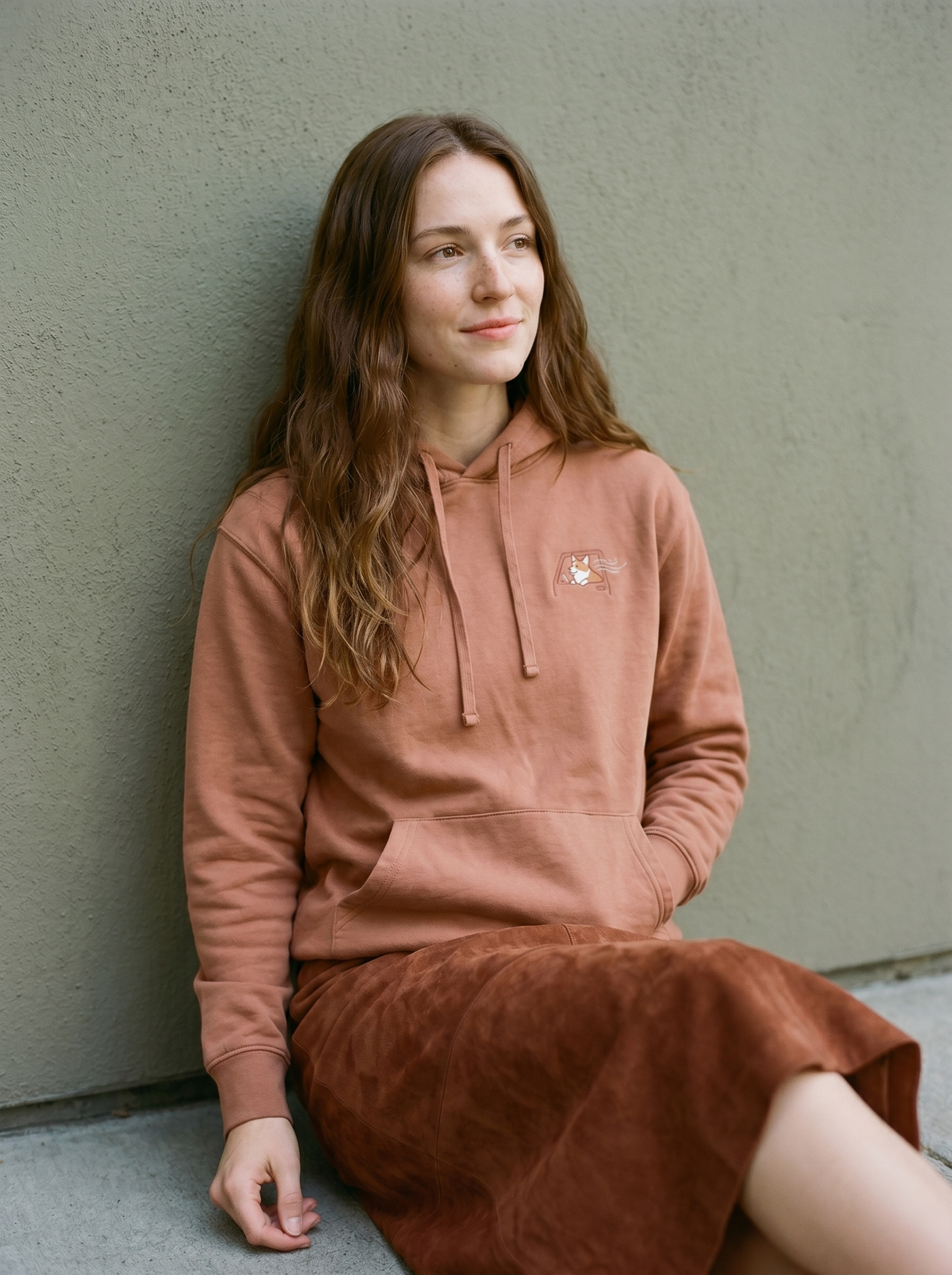 embroidered roadtrip corgi hoodie - model seated
